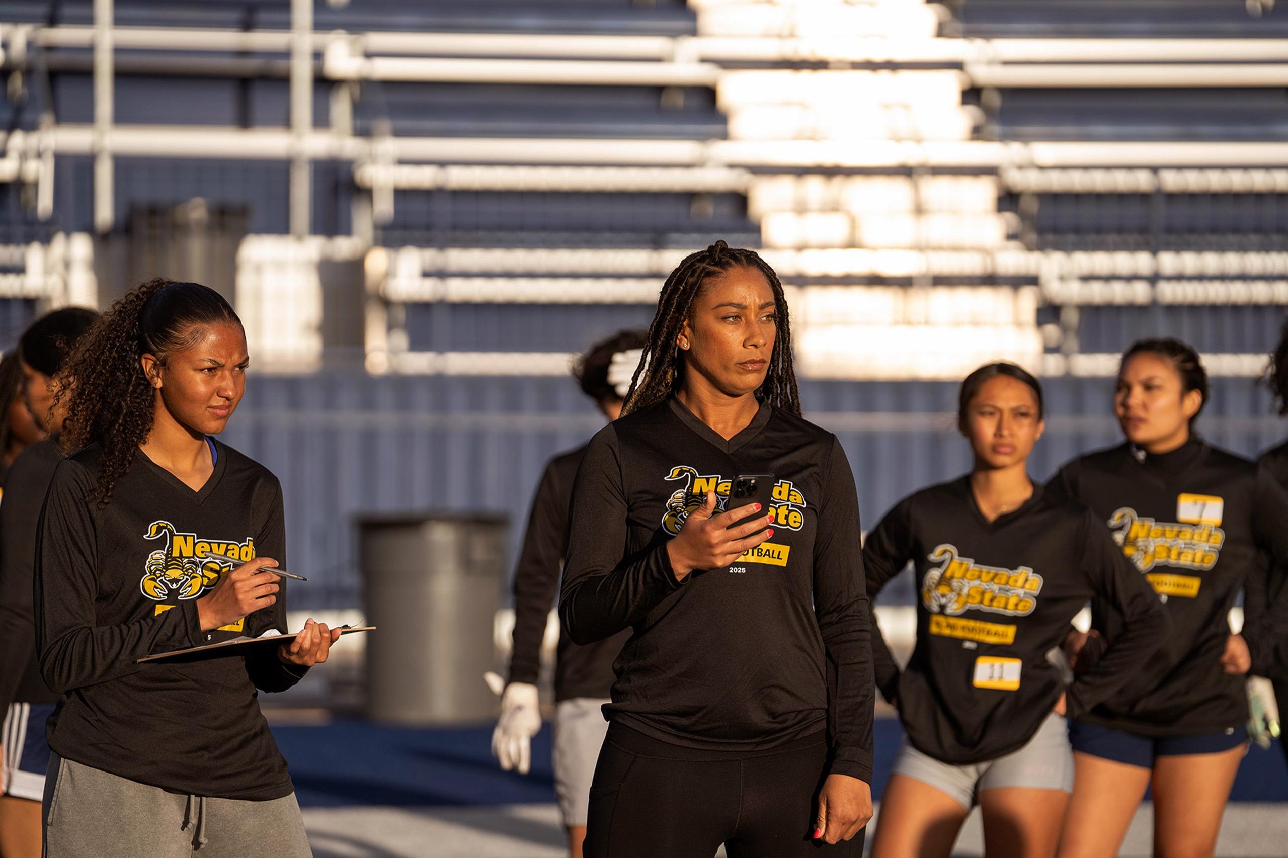 Women's flag football players running a coordinated offensive play during team training session