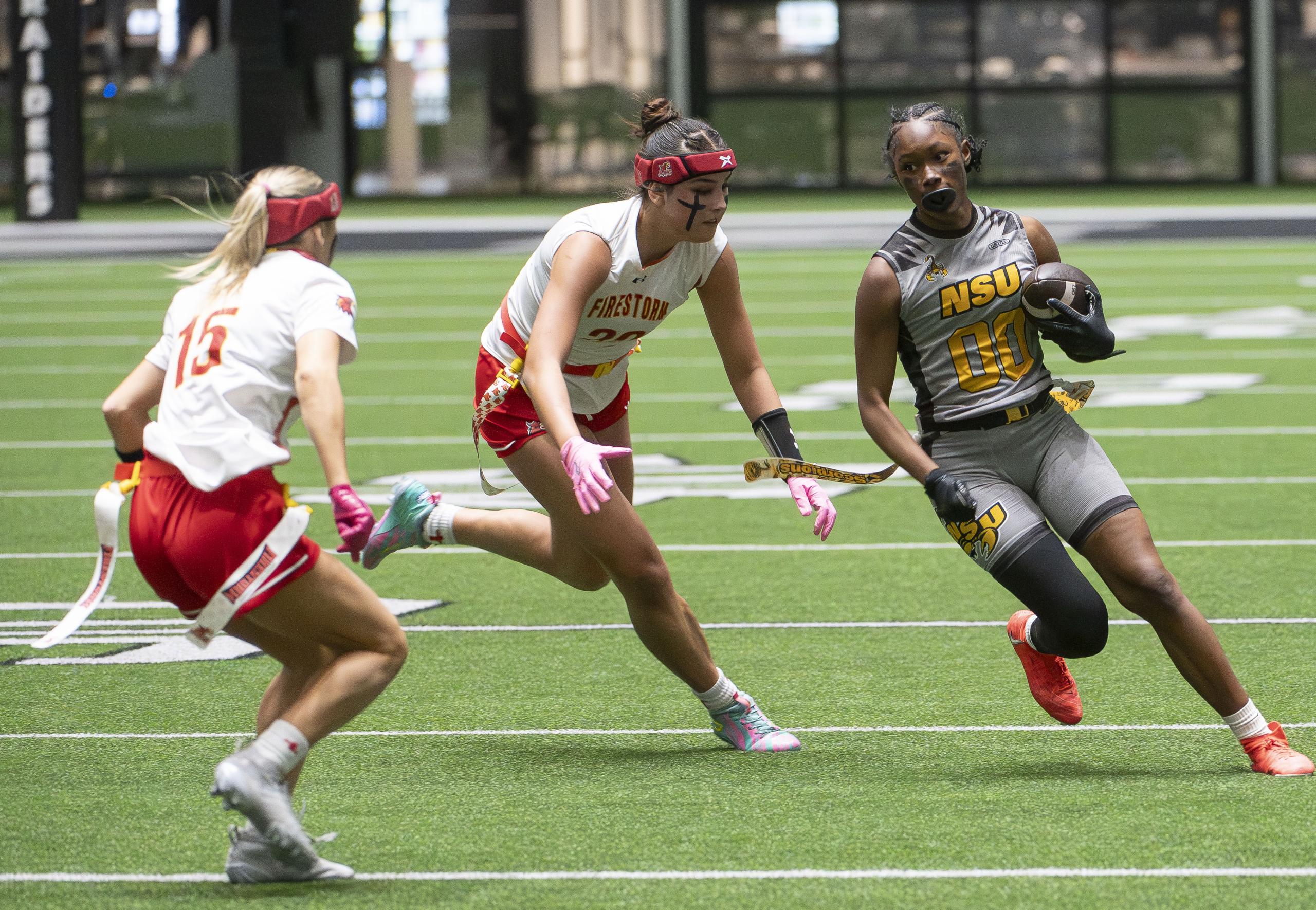Nevada State flag football player runs along the sideline vs Arizona Christian University
